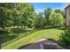 A sprawling green backyard with lush grass and a black metal fence in a tree-lined area at 2933 Elmfield St, Raleigh, NC 27614