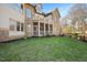 Beautiful backyard featuring a covered porch, balcony, brick exterior, and well-maintained lawn at 2933 Elmfield St, Raleigh, NC 27614