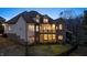 Back of house featuring expansive windows, deck, patio, and well-manicured lawn at 2933 Elmfield St, Raleigh, NC 27614