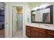 Bathroom featuring a single vanity with wood cabinets and an open doorway to a shower at 2933 Elmfield St, Raleigh, NC 27614