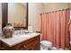 Bathroom featuring a granite countertop, wood cabinetry and peach accents at 2933 Elmfield St, Raleigh, NC 27614