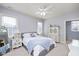 Cozy bedroom with a grey bed, white dresser, and plenty of natural light coming through the window at 2933 Elmfield St, Raleigh, NC 27614