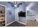Attic bedroom with built-in shelving, a flat screen television, and a ceiling fan at 2933 Elmfield St, Raleigh, NC 27614