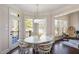 Bright breakfast nook with hardwood floors, a white table set, and a large window with views of the yard at 2933 Elmfield St, Raleigh, NC 27614