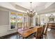 Light-filled dining room with hardwood floors, a classic chandelier, and a large window overlooking the neighborhood at 2933 Elmfield St, Raleigh, NC 27614