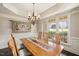 Elegant dining room with hardwood floors, stylish chandelier, and large windows for plenty of light at 2933 Elmfield St, Raleigh, NC 27614