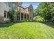The exterior of a tan colored home featuring a deck, screened-in porch, and well-manicured lawn at 2933 Elmfield St, Raleigh, NC 27614