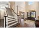 Grand foyer featuring hardwood floors, staircase, and beautiful front door with sidelights at 2933 Elmfield St, Raleigh, NC 27614