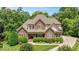 Attractive stone-and-siding home featuring lush landscaping, a manicured lawn, and a covered porch at 2933 Elmfield St, Raleigh, NC 27614
