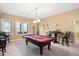 Spacious game room with pool table, multiple windows, and comfortable seating at 2933 Elmfield St, Raleigh, NC 27614