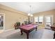 Spacious game room with a pool table, bright lighting, and ample space for entertaining at 2933 Elmfield St, Raleigh, NC 27614