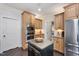 Well-lit kitchen with wooden cabinets, stainless steel appliances, and granite countertops on the kitchen island at 2933 Elmfield St, Raleigh, NC 27614