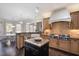 Spacious kitchen featuring a large island, custom cabinets, granite countertops, and modern appliances at 2933 Elmfield St, Raleigh, NC 27614