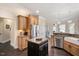 Open kitchen with stainless steel appliances, a center island, granite counters, and hardwood floors at 2933 Elmfield St, Raleigh, NC 27614