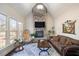 Comfortable living room featuring a stone fireplace, vaulted ceiling, and large windows providing natural light at 2933 Elmfield St, Raleigh, NC 27614