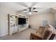 Bright living room with a brown couch, built in shelves, and a ceiling fan at 2933 Elmfield St, Raleigh, NC 27614