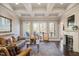 Bright living room features a fireplace, coffered ceilings, and large windows for natural light at 2933 Elmfield St, Raleigh, NC 27614