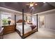 Comfortable bedroom with a four-poster bed, tray ceiling, and en-suite bathroom at 2933 Elmfield St, Raleigh, NC 27614