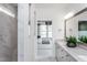 Well-lit bathroom featuring marble floors and shower, double vanity, and a view into the bedroom at 294 Arcadius Dr, Clayton, NC 27520