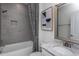 Modern bathroom featuring a tub-shower combination, gray tile, and a granite countertop at 294 Arcadius Dr, Clayton, NC 27520