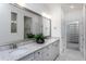 Bright bathroom with double vanity, a large mirror, and white cabinets at 294 Arcadius Dr, Clayton, NC 27520