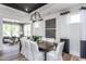 Modern dining room with elegant lighting, stylish decor, and an adjacent living space at 294 Arcadius Dr, Clayton, NC 27520