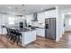 Bright kitchen featuring a large island with seating, stainless steel appliances, and white cabinetry at 294 Arcadius Dr, Clayton, NC 27520