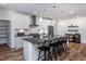 Modern kitchen with a large island, stainless steel appliances, and sleek white cabinets at 294 Arcadius Dr, Clayton, NC 27520