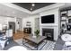 Open concept living room features a fireplace, a grey sofa, and modern décor at 294 Arcadius Dr, Clayton, NC 27520