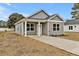 An inviting single story home featuring a gray exterior, well-maintained landscaping, and a concrete driveway at 307 Wondertown Dr, Erwin, NC 28339