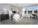 Cozy main bedroom with a large window, neutral walls, comfortable bed, and stylish decor at 312 Church St # 36, Wendell, NC 27591