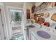 Functional laundry room with washer, dryer, shelving and decor at 3134 Magnolia Ln, Stem, NC 27581