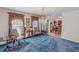 Formal living room featuring a chandelier, elegant curtains, and a glimpse into the dining area at 3134 Magnolia Ln, Stem, NC 27581