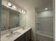 Bathroom featuring double vanity with a large mirror and modern lighting at 314 Church St # 37, Wendell, NC 27591