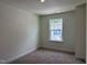 Bedroom with a view, ample natural light and neutral carpeting at 314 Church St # 37, Wendell, NC 27591
