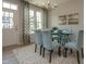 Elegant dining area with a glass table, patterned chairs, modern chandelier, and lots of natural light at 314 Church St # 37, Wendell, NC 27591