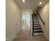 Inviting hallway with a staircase and views into the kitchen, creating a sense of openness at 314 Church St # 37, Wendell, NC 27591