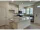 Bright kitchen with white cabinets, granite countertops, stainless steel appliances, and a large center island at 314 Church St # 37, Wendell, NC 27591