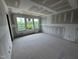 Spacious new bedroom showing a view of the backyard and drywall finishing at 315 Chesapeake Commons St # 102, Garner, NC 27529