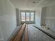A new construction living room featuring multiple windows for natural light at 315 Chesapeake Commons St # 102, Garner, NC 27529