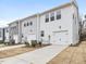 Exterior view of townhomes with garage, double windows and grey and white vinyl siding at 318 Church St # 39, Wendell, NC 27591