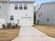 View of townhome with a driveway, garage and lush greenery at 318 Church St # 39, Wendell, NC 27591