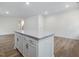 Bright kitchen features a spacious island with granite countertops and white cabinetry at 318 Church St # 39, Wendell, NC 27591