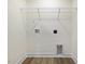 Bright laundry room with hookups, shelving and vinyl floors at 318 Church St # 39, Wendell, NC 27591