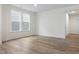 Bright, neutral living room featuring wood-look floors and a dual-window letting in natural light at 318 Church St # 39, Wendell, NC 27591
