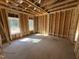 Framed bedroom area showcasing natural light with windows, open space and design potential at 327 S Main St, Four Oaks, NC 27524