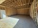 Spacious garage area with framing and concrete floor, ready for customization at 327 S Main St, Four Oaks, NC 27524