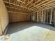 Large garage space with exposed framing, concrete floor, offering potential for customization at 327 S Main St, Four Oaks, NC 27524