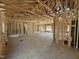 Interior view of a home under construction, showcasing open framing and high ceilings, plus a window at 327 S Main St, Four Oaks, NC 27524