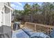 Cozy back deck with a grill, seating, and a view of the wooded backyard at 329 Silver Creek Dr, Clayton, NC 27520